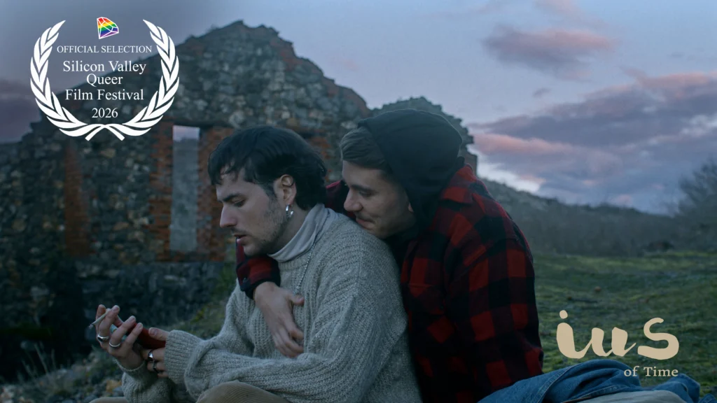 IUS del tiempo seleccionado en el Silicon Valley Queer Film Festival 2026 -
 Film still from the short film “IUS of Time” showing Luca (Pelayo Carrizo) and Rodri (Andy Almar) at an abandoned mine, featuring the Official Selection laurel of the 4th Silicon Valley Queer Film Festival, United States, 2026.