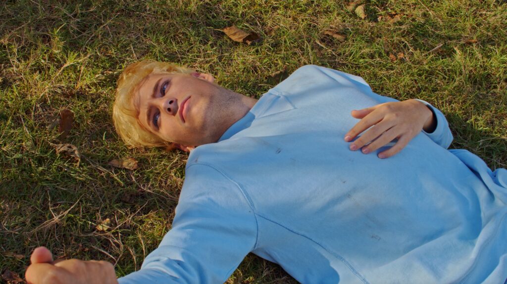 Nico (Pelayo Carrizo), lying on the ground – Water Circles Under Cotton Clouds (2023)