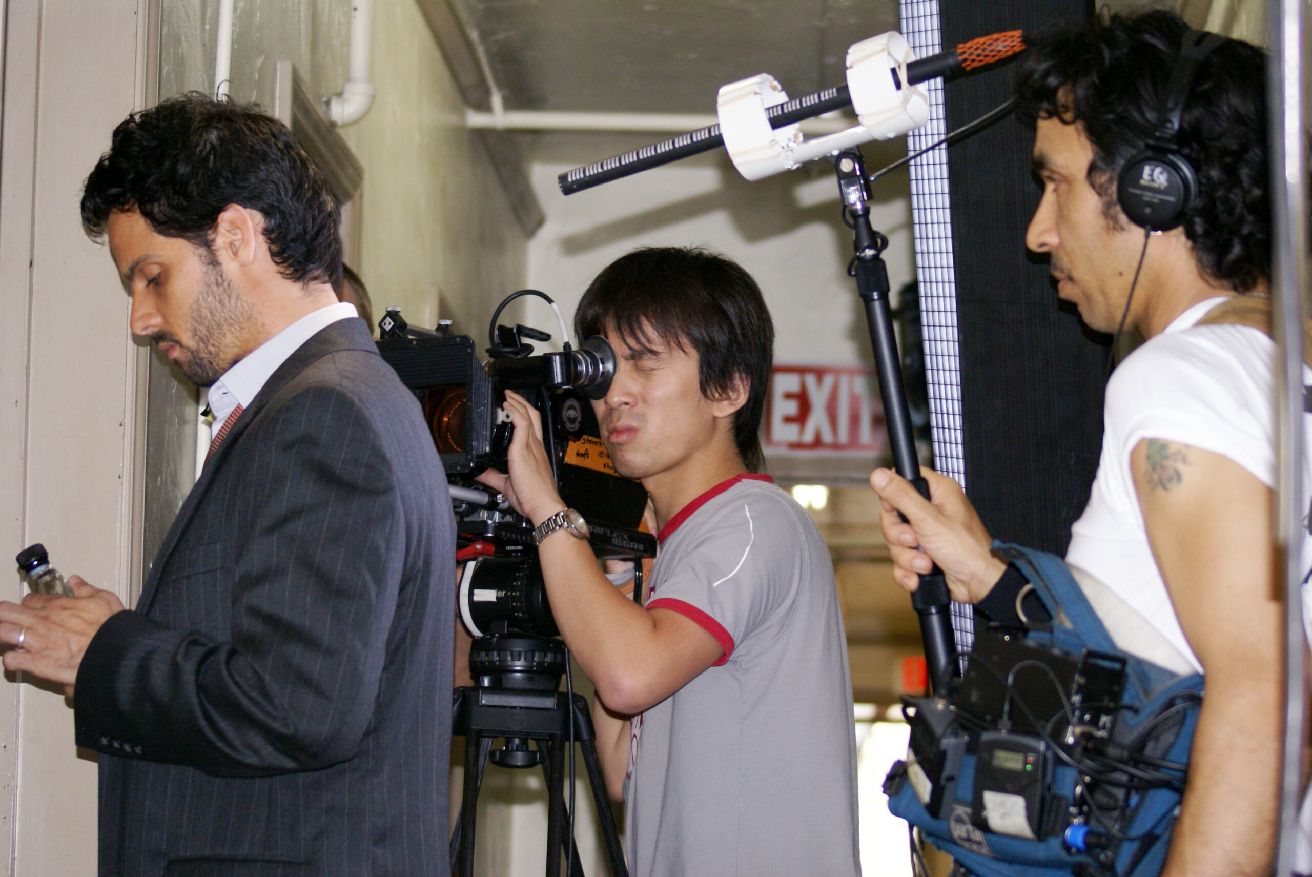 Xu Xiaoxi, director of photography and co-director, behind the scenes of the feature film Desire Street, together with an actor and a member of the sound team in Los Angeles.