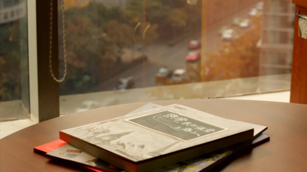 Still from the corporate tribute video for New Oriental School’s 10th anniversary (2013), teachers and staff reflecting on experiences in Beijing, China