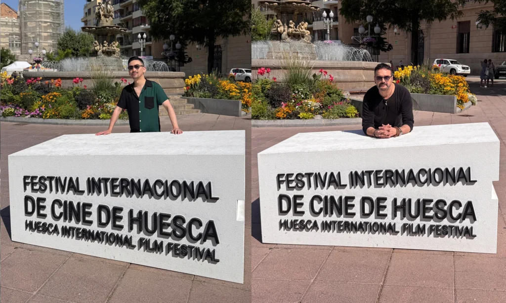 Directors Roberto F. Canuto and Xu Xiaoxi posing next to the large festival sign structure of the 53rd Huesca International Film Festival, an Oscar-qualifying festival, for the short film “IUS of Time”, Spain, 2025.