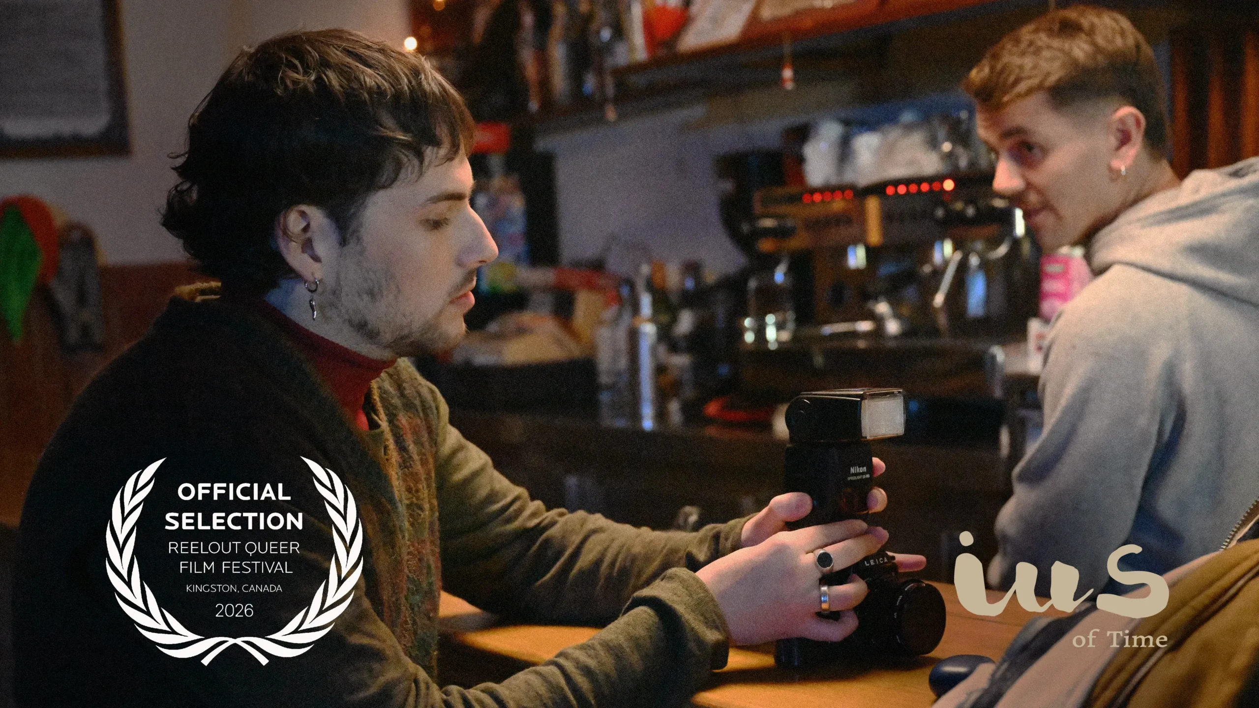 Behind-the-scenes still from IUS of Time, featuring Pelayo Carrizo and Andy Almar on set at the bar-shop location in Asturias, during the filming of the short film selected at ReelOut Queer Film Festival