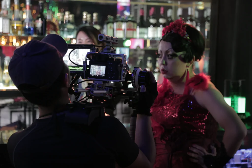 Film crew operating camera during cabaret scene shoot in Sunken Plum