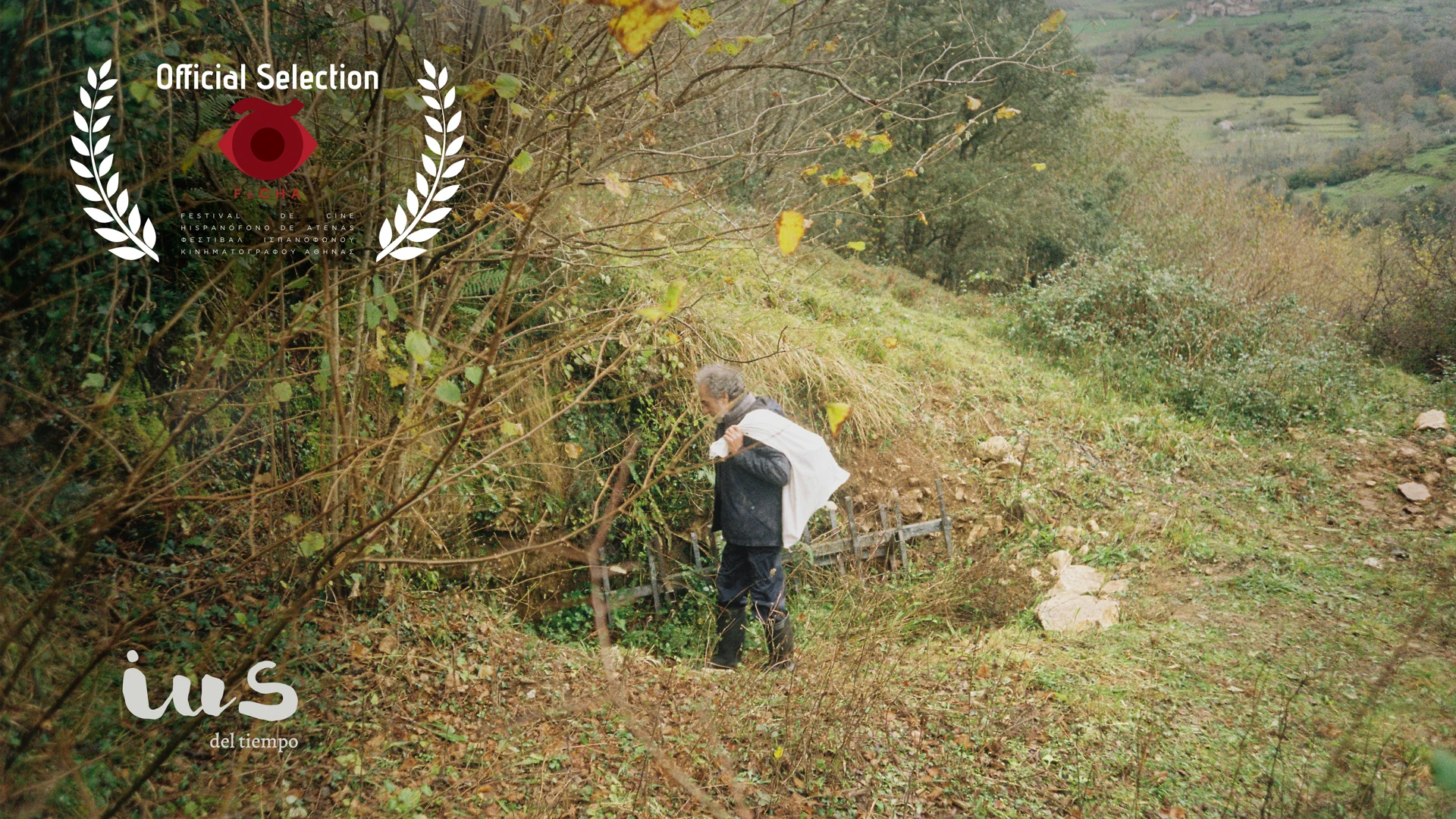 Analog behind-the-scenes photograph from IUS of Time by Elmer Guevara, featuring the Asturian rural landscape alongside the official logo of the 10th FeCHA Athens Spanish-Language Film Festival 2026