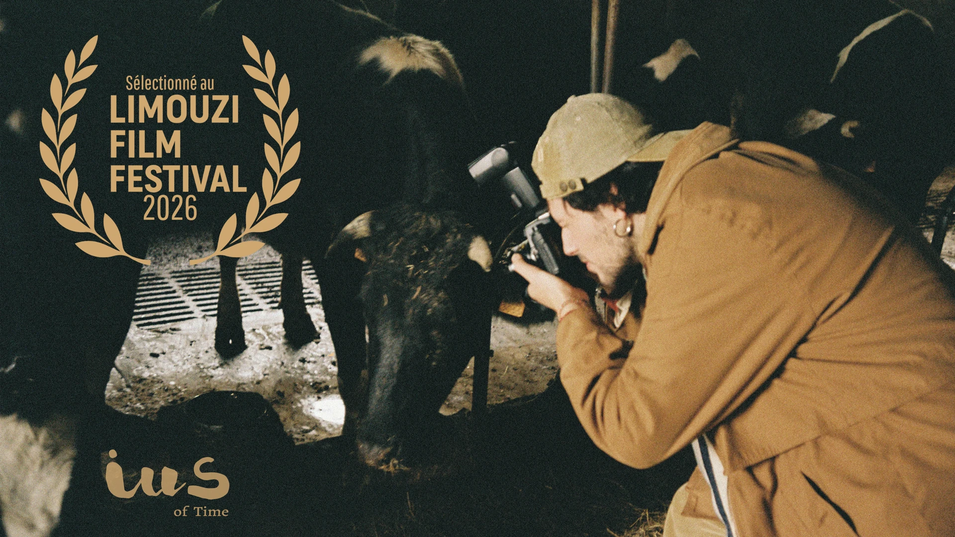 Pelayo Carrizo as Luca photographing a cow in an Asturian stable in IUS of Time, with Limouzi Film Festival 2026 laurels.